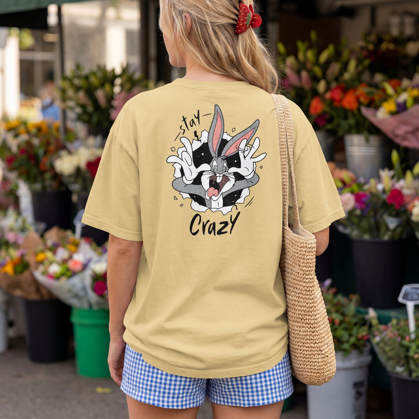 Beige oversized unisex t-shirt with a Stay Crazy Bugs Bunny graphic breaking through the fabric, back view