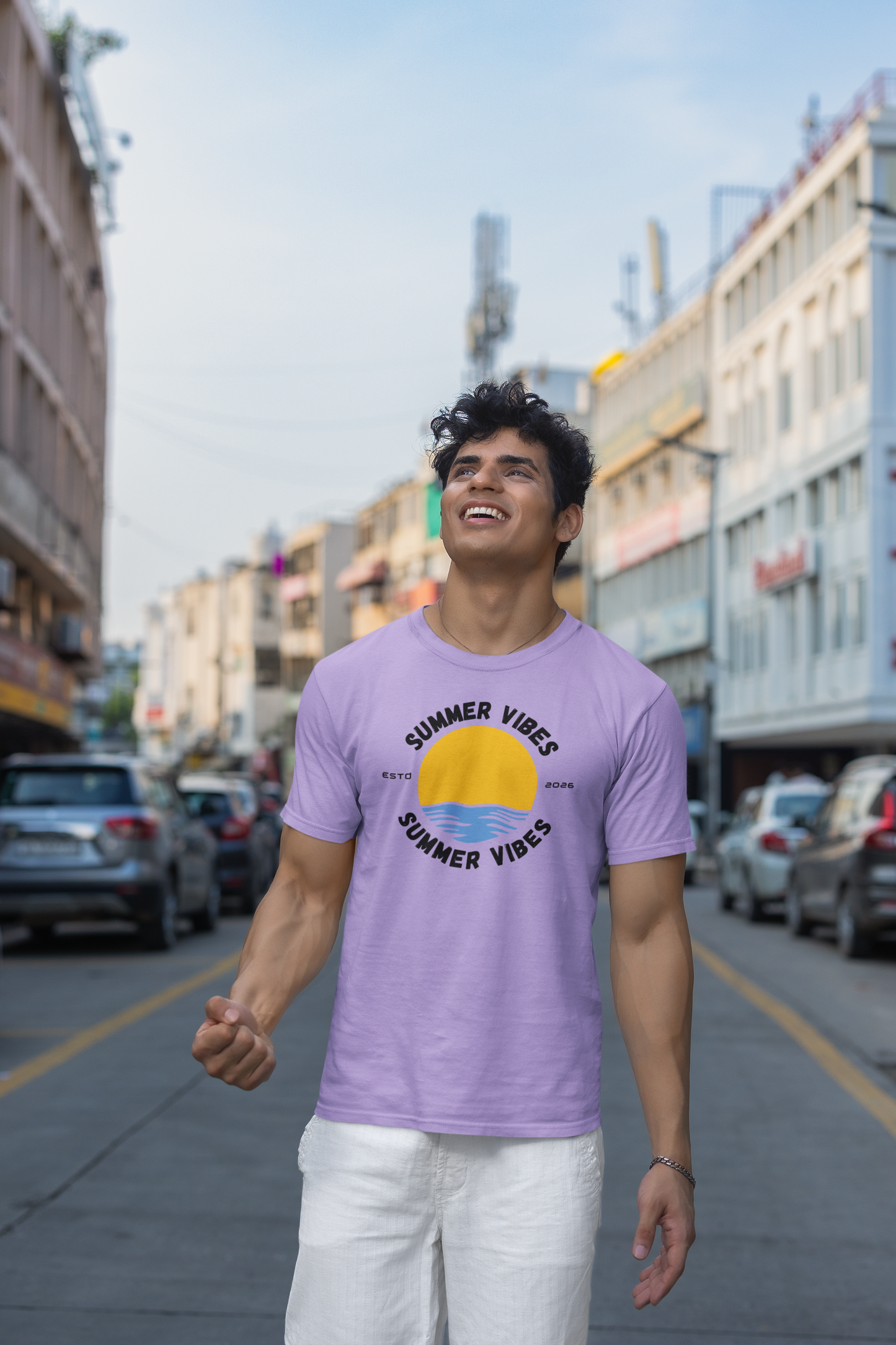 Man wearing a lavender 'Summer Vibes' t-shirt on a city street