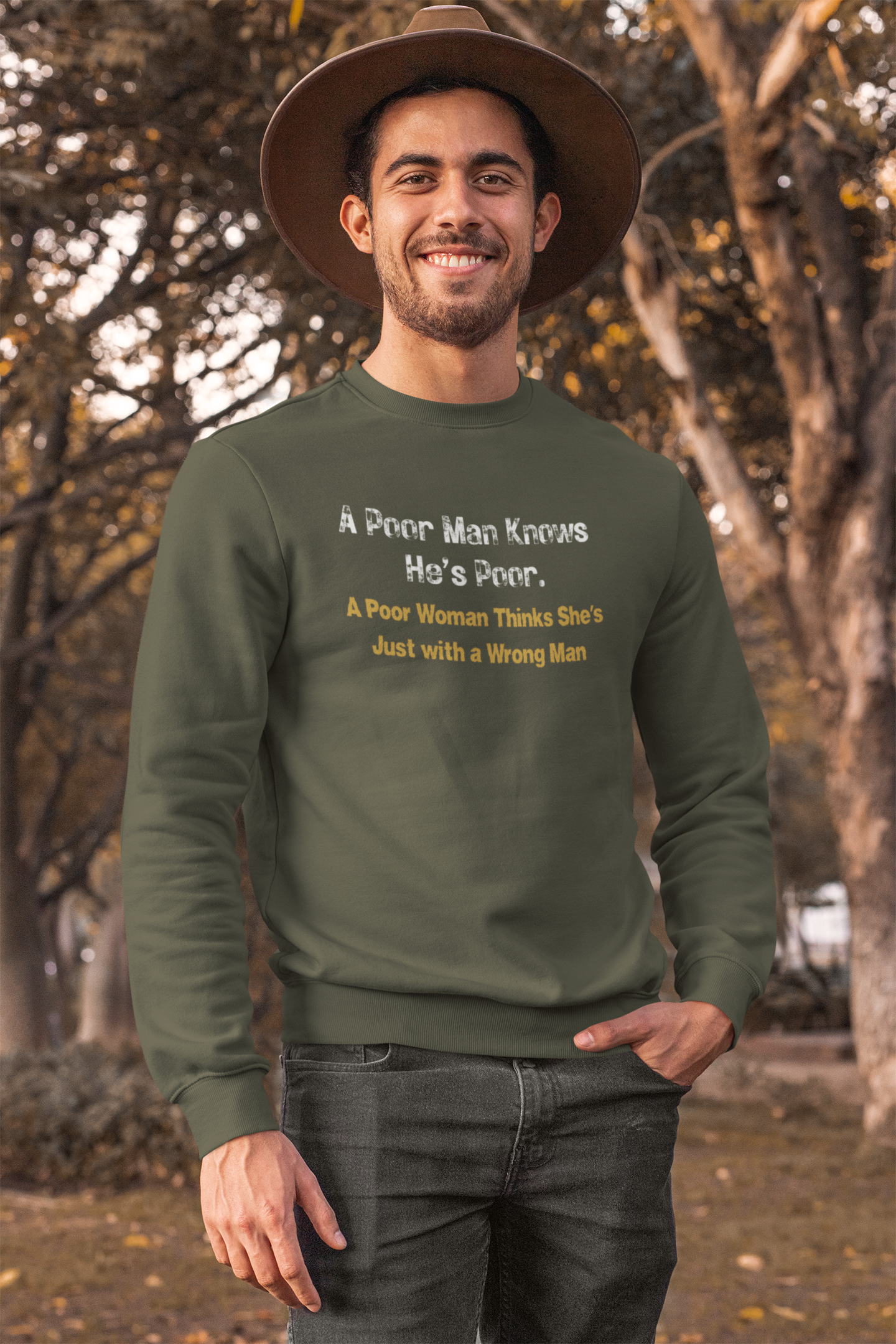 Man wearing a olive green sweatshirt with humorous text in an outdoor setting