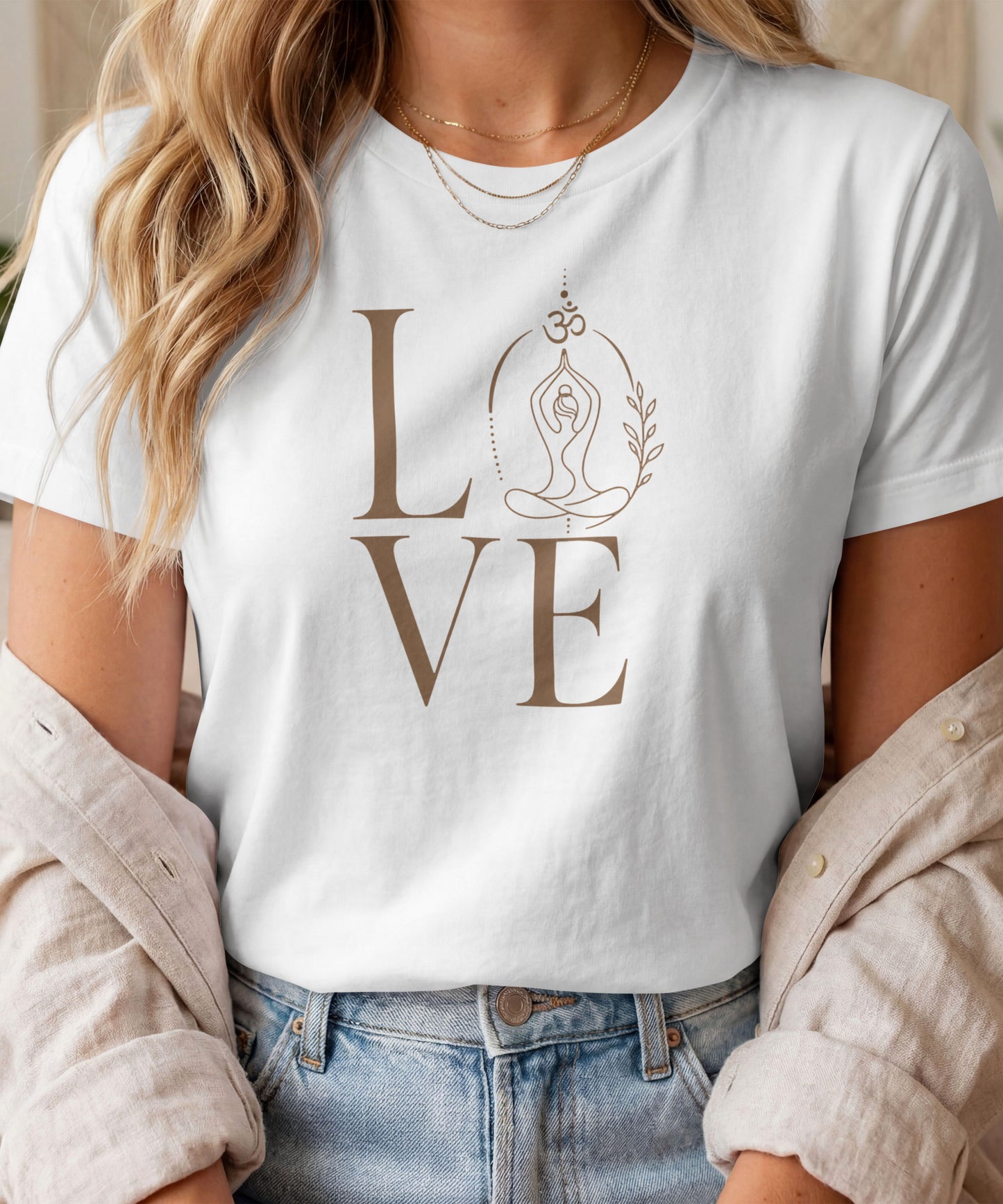 A woman modelling a white graphic t-shirt featuring a minimalist "LOVE" design with a meditating yoga pose and an Om symbol
