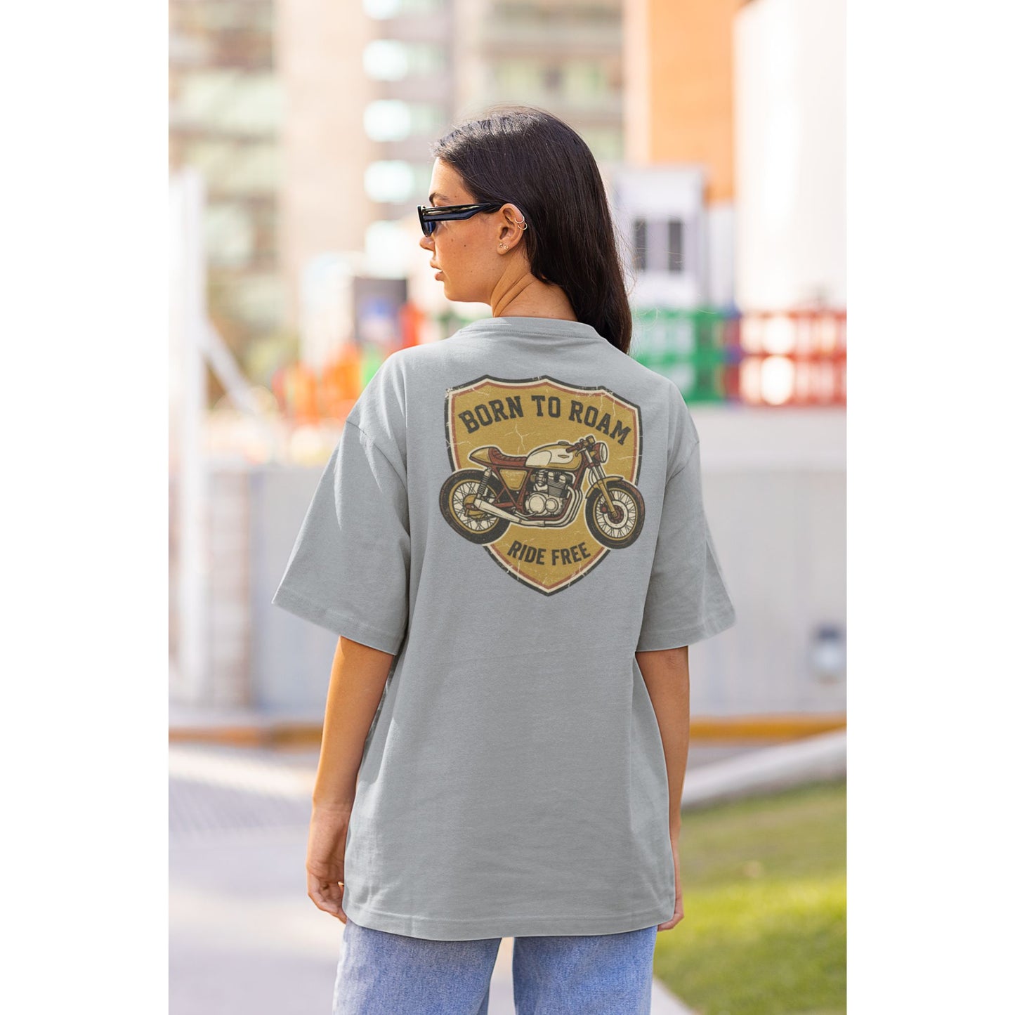Female model wearing the Nauma Born To Roam cafe racer oversized t-shirt in Silver Frost grey, boxy unisex fit