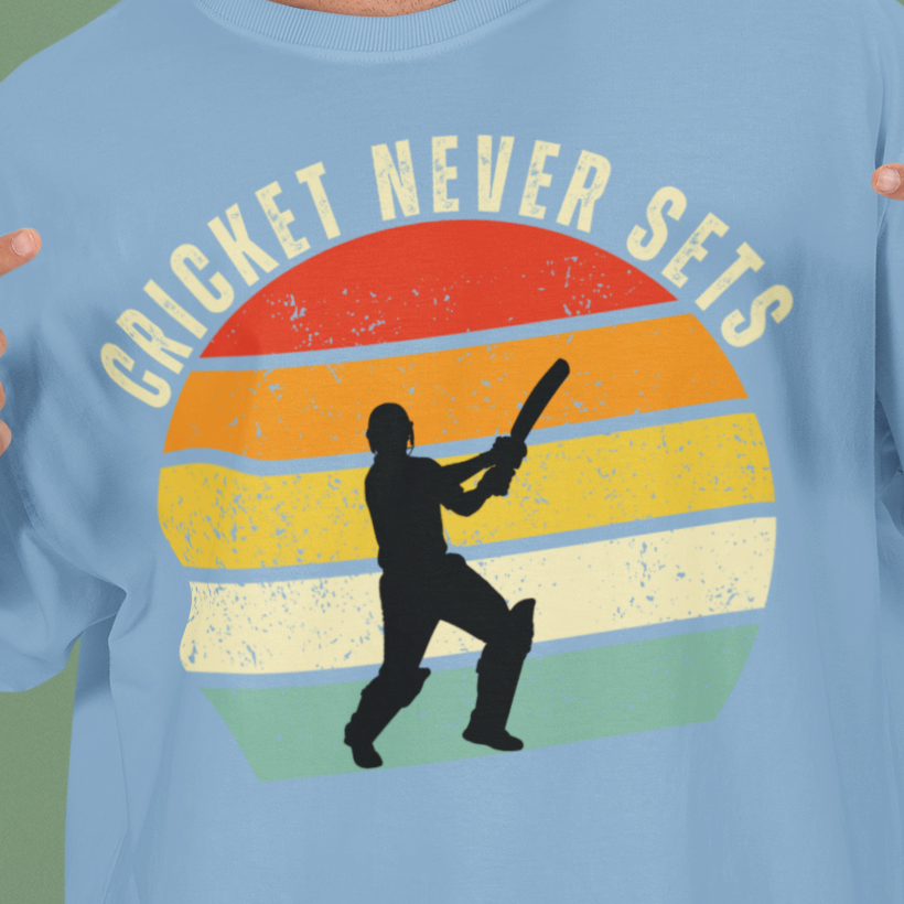 Baby Blue Cricket Never Sets t-shirt close-up of the distressed vintage sunset print with batsman silhouette