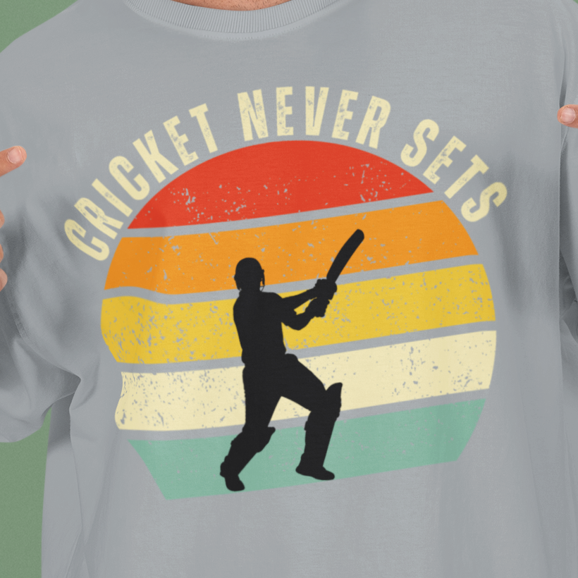 Silver Frost Cricket Never Sets t-shirt close-up of the distressed vintage sunset print with batsman silhouette