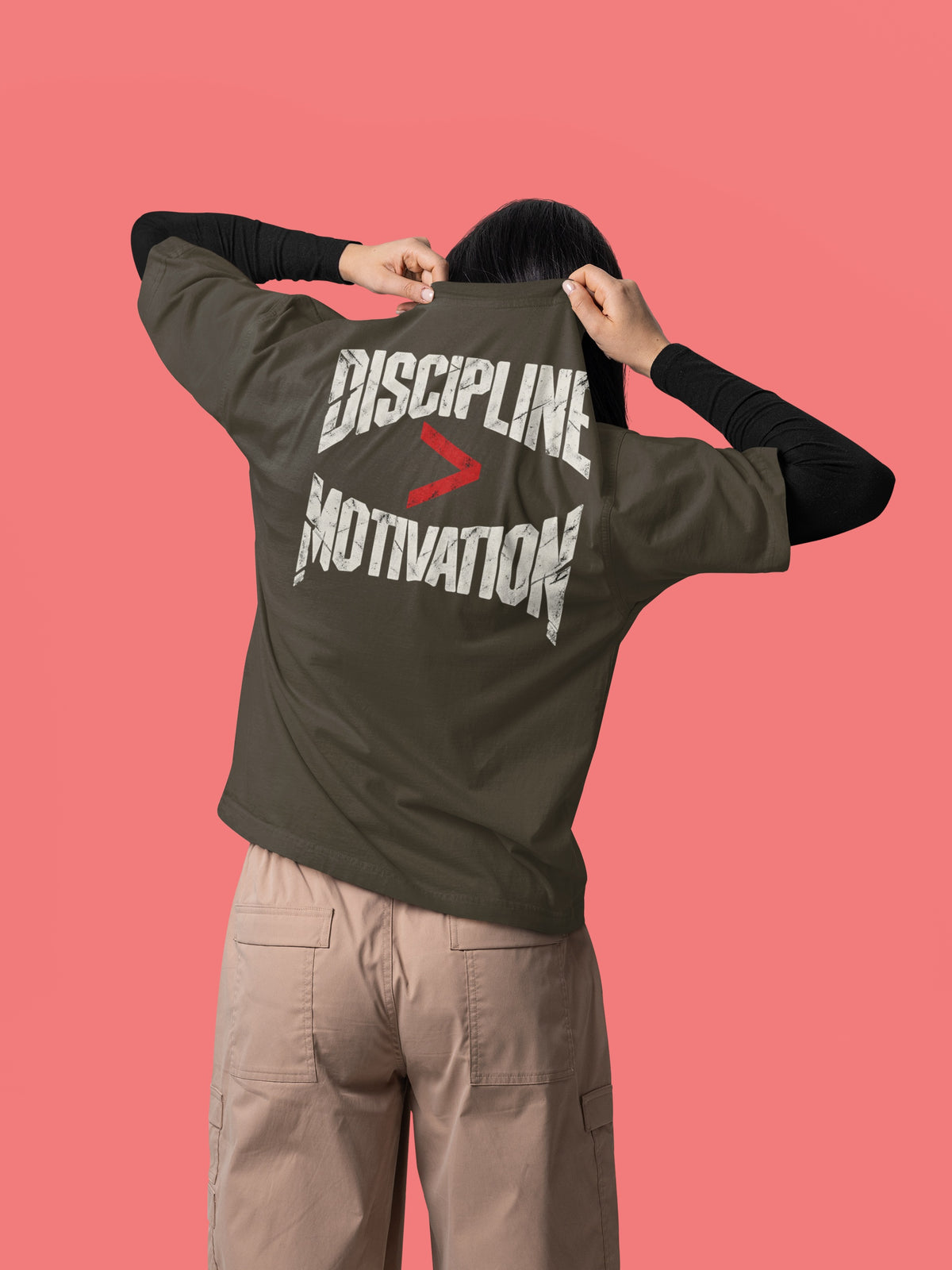 Olive Green Discipline Over Motivation back print unisex oversized t-shirt worn by a woman, back view