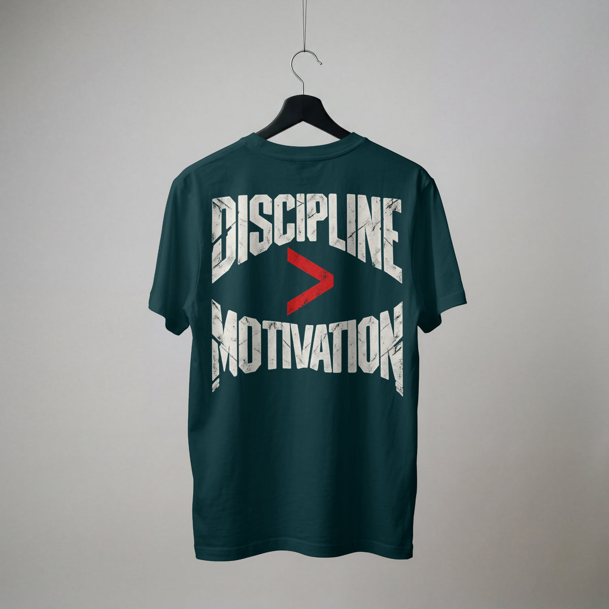 Petrol Blue Discipline Over Motivation oversized t-shirt on a hanger, showing the back print