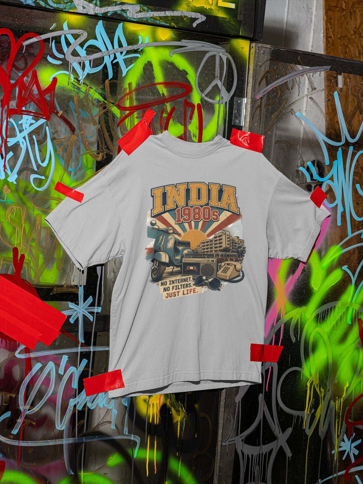 Melange Grey India 80s retro oversized t-shirt hanging on a graffiti wall – front view