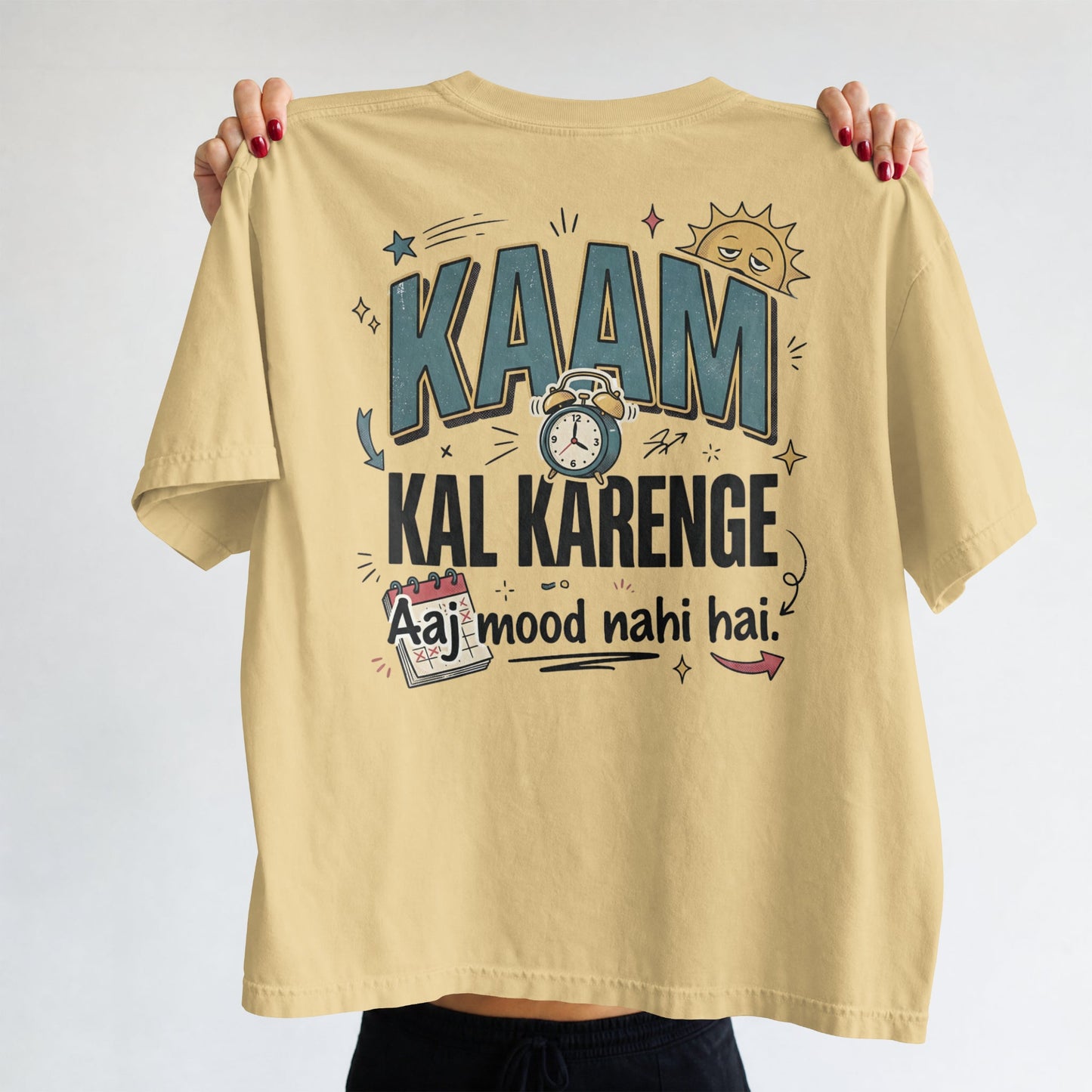 Beige Nauma oversized t-shirt, front view, with bold 'Kaam Kal Karenge' typography and doodle-style graphic.
