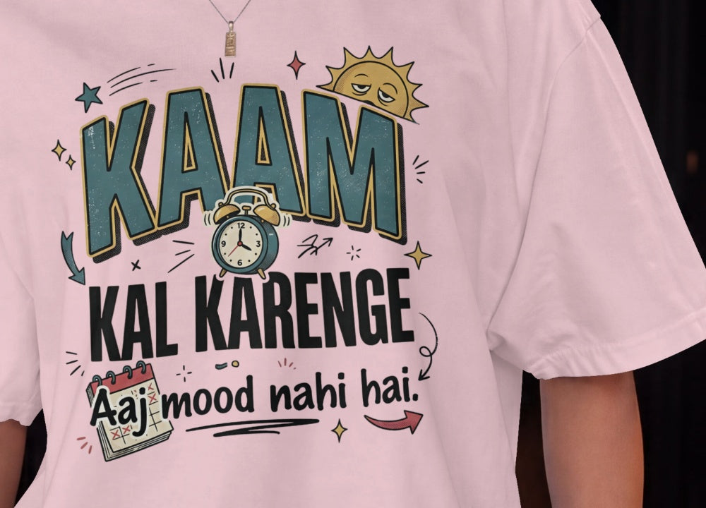 Light baby pink Nauma oversized t-shirt design close-up of 'Kaam Kal Karenge' typography and doodle art.