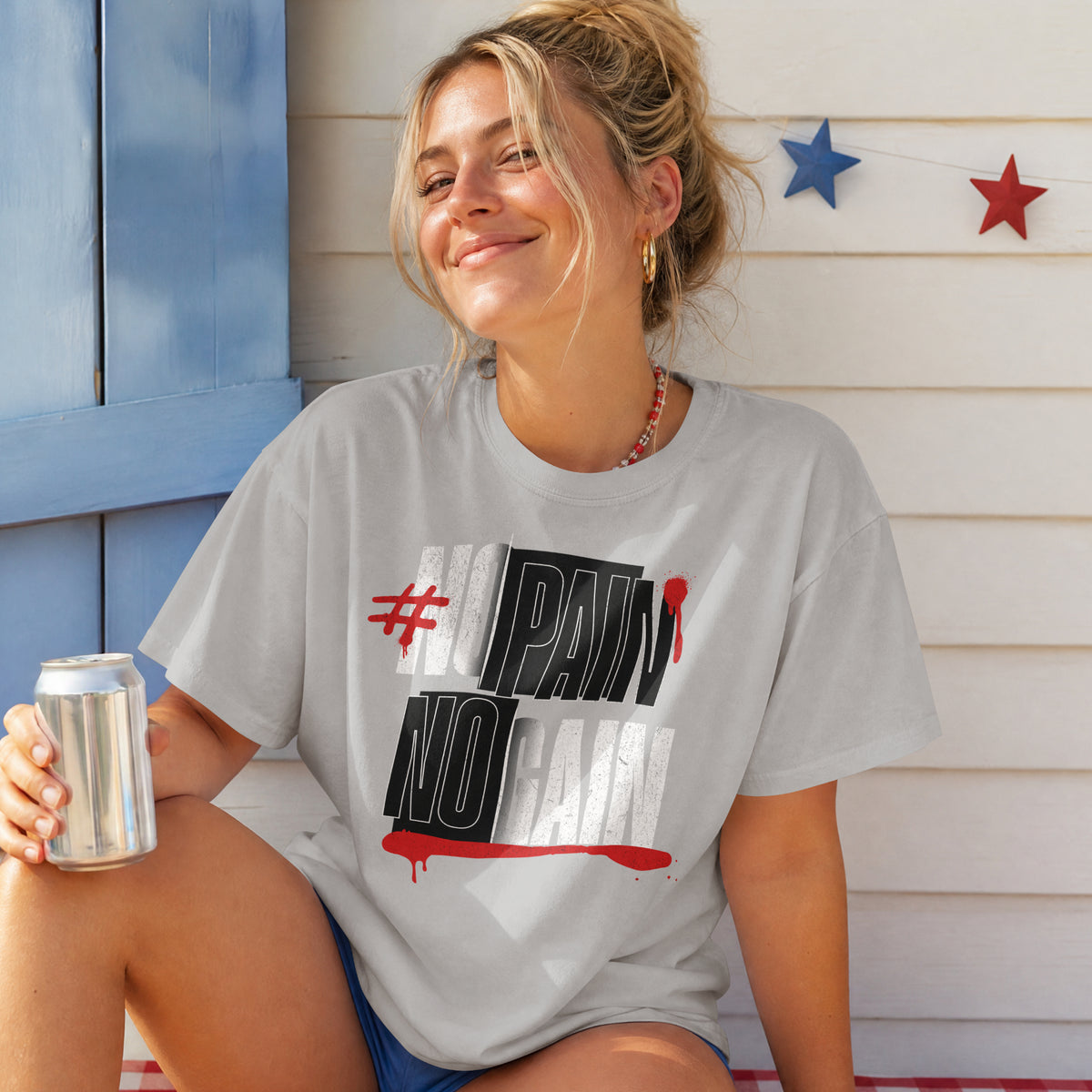 Woman wearing the melange grey No Pain No Gain oversized T-shirt, black and white gym print with red drip accents