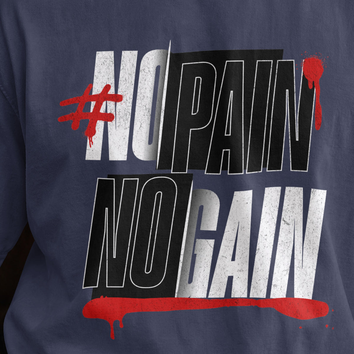 Close-up of the No Pain No Gain chest print on a navy blue oversized T-shirt, distressed condensed lettering