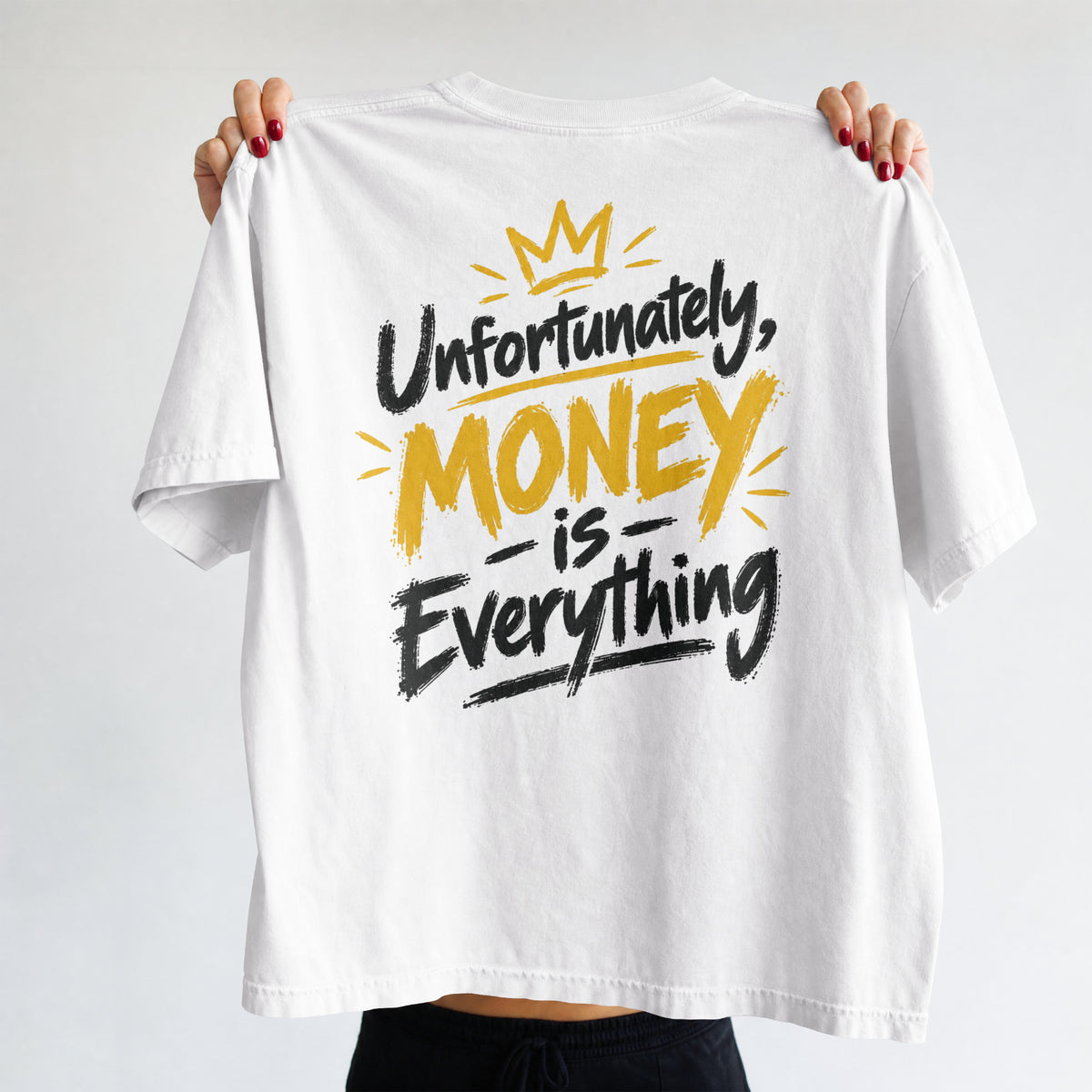 White Unfortunately Money Is Everything oversized T-shirt held up to show the dark back slogan print with MONEY in mustard yellow
