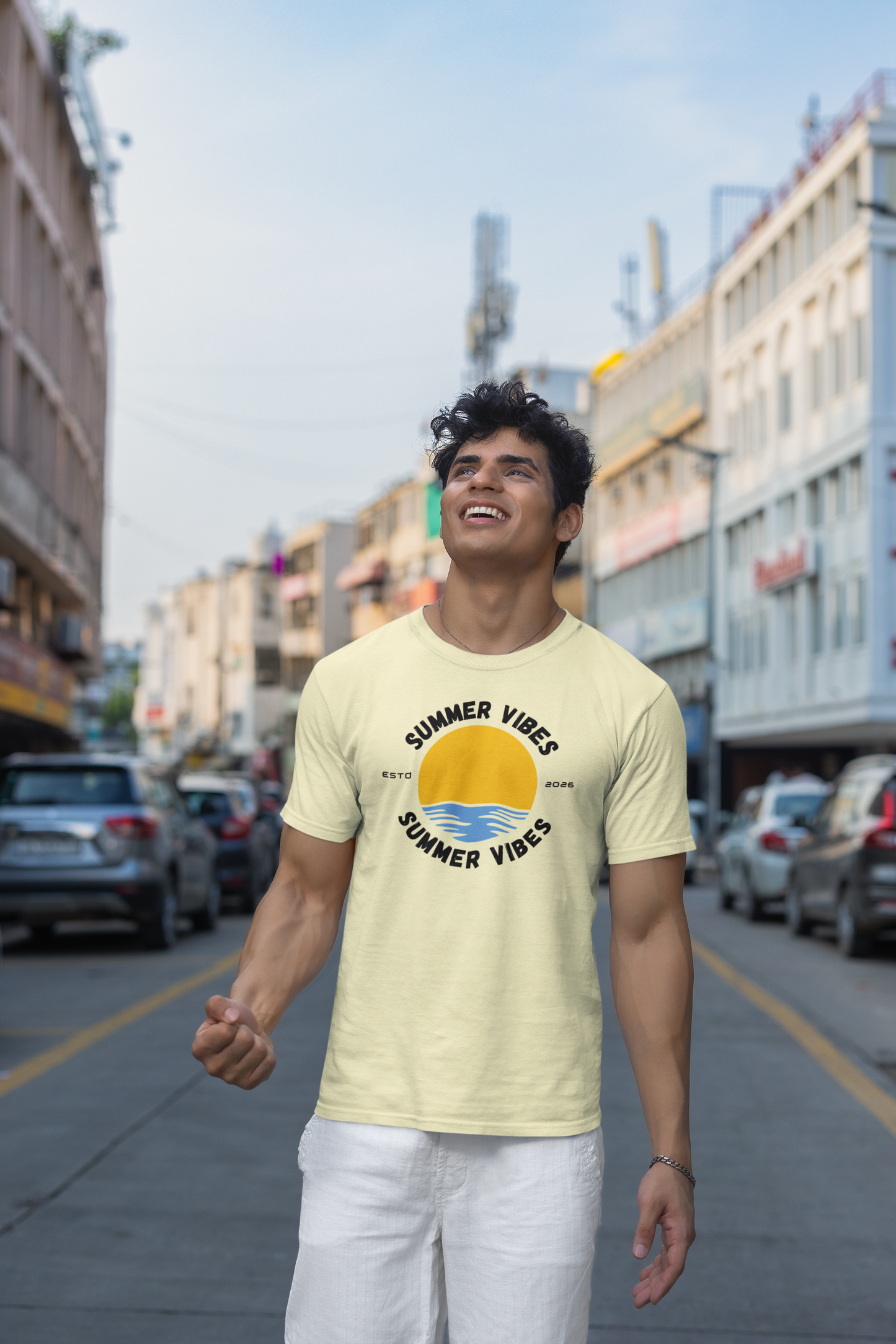 Man wearing a almond 'Summer Vibes' t-shirt on a city street