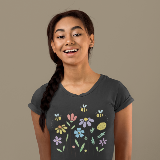 Young woman wearing a black t-shirt with colorful floral designs.