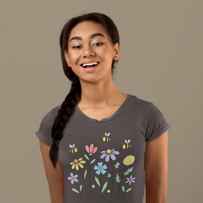 Young woman wearing a charcoal grey t-shirt with colorful floral designs.