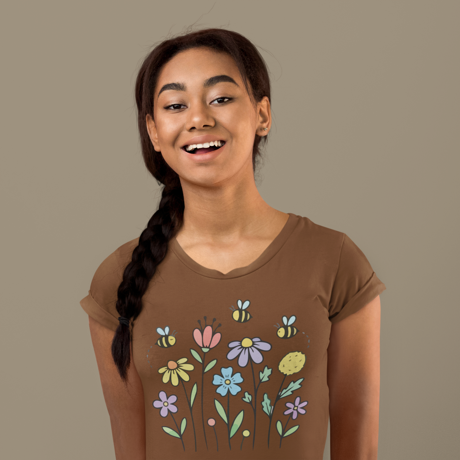 Young woman wearing a coffee brown t-shirt with colorful floral designs.
