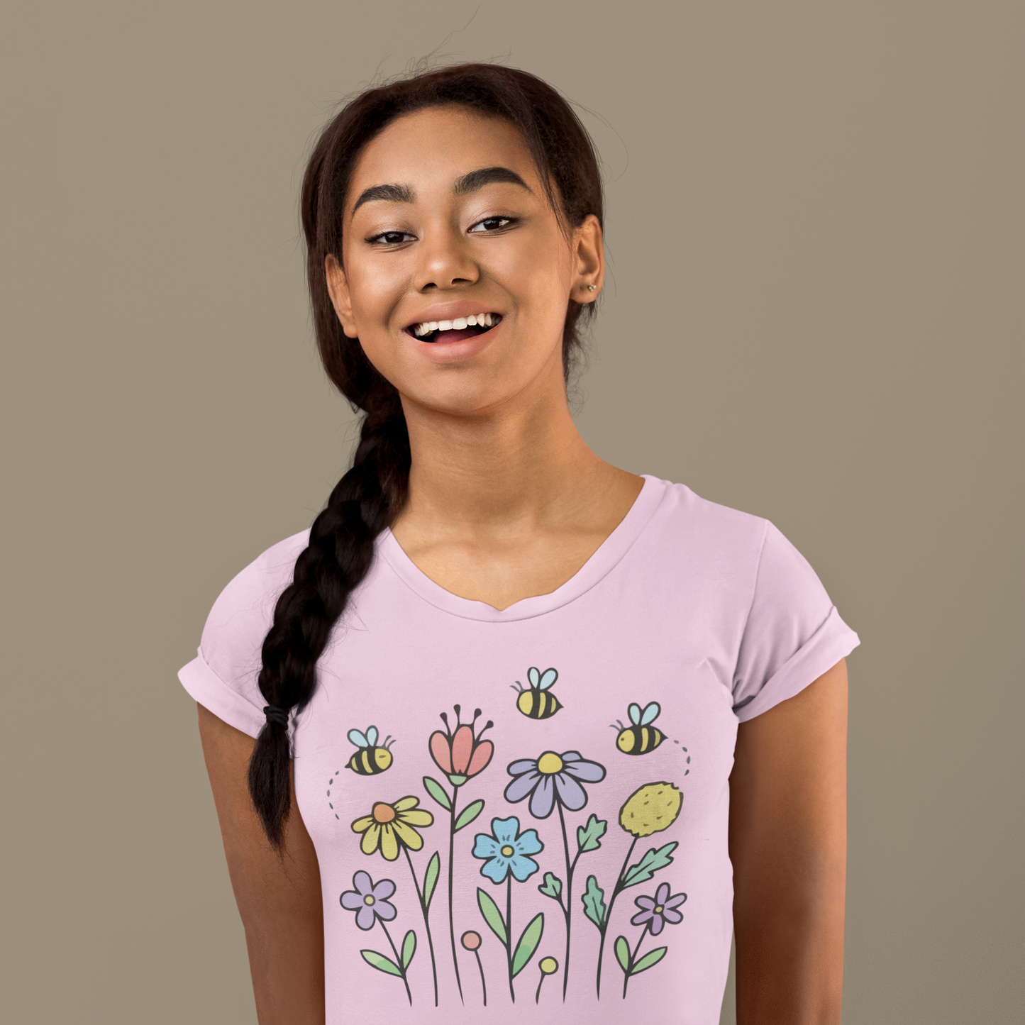 Young woman wearing a light pink t-shirt with colorful floral designs.