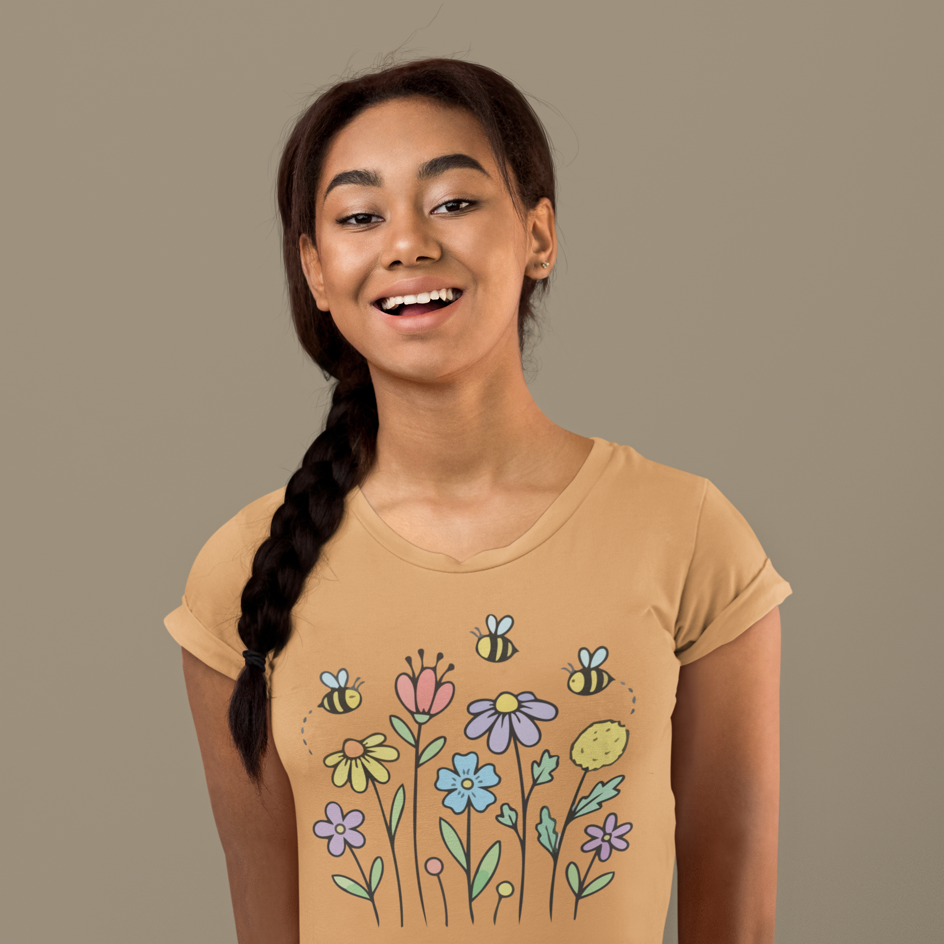 Young woman wearing a mustard yellow t-shirt with colorful floral designs.