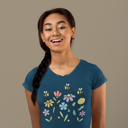 Young woman wearing a navy blue t-shirt with colorful floral designs.