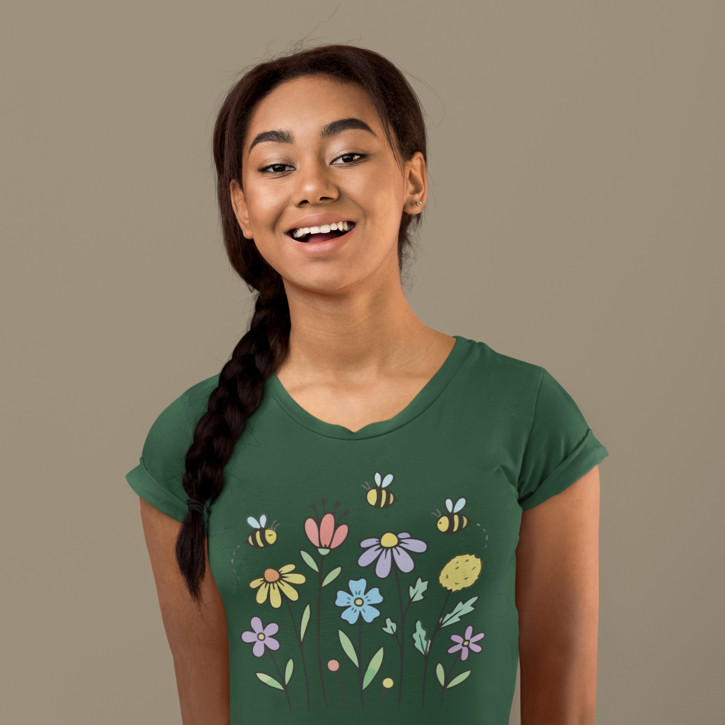 Young woman wearing a olive green t-shirt with colorful floral designs.