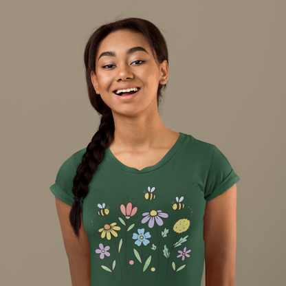 Young woman wearing a olive green t-shirt with colorful floral designs.