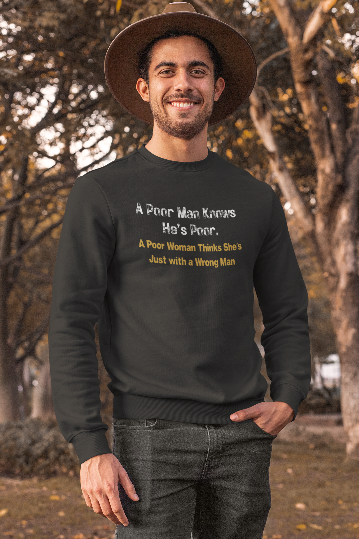 Man wearing a black sweatshirt with humorous text in an outdoor setting