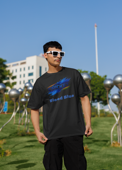 Person wearing a black t-shirt with a colorful graphic design outdoors on a sunny day.