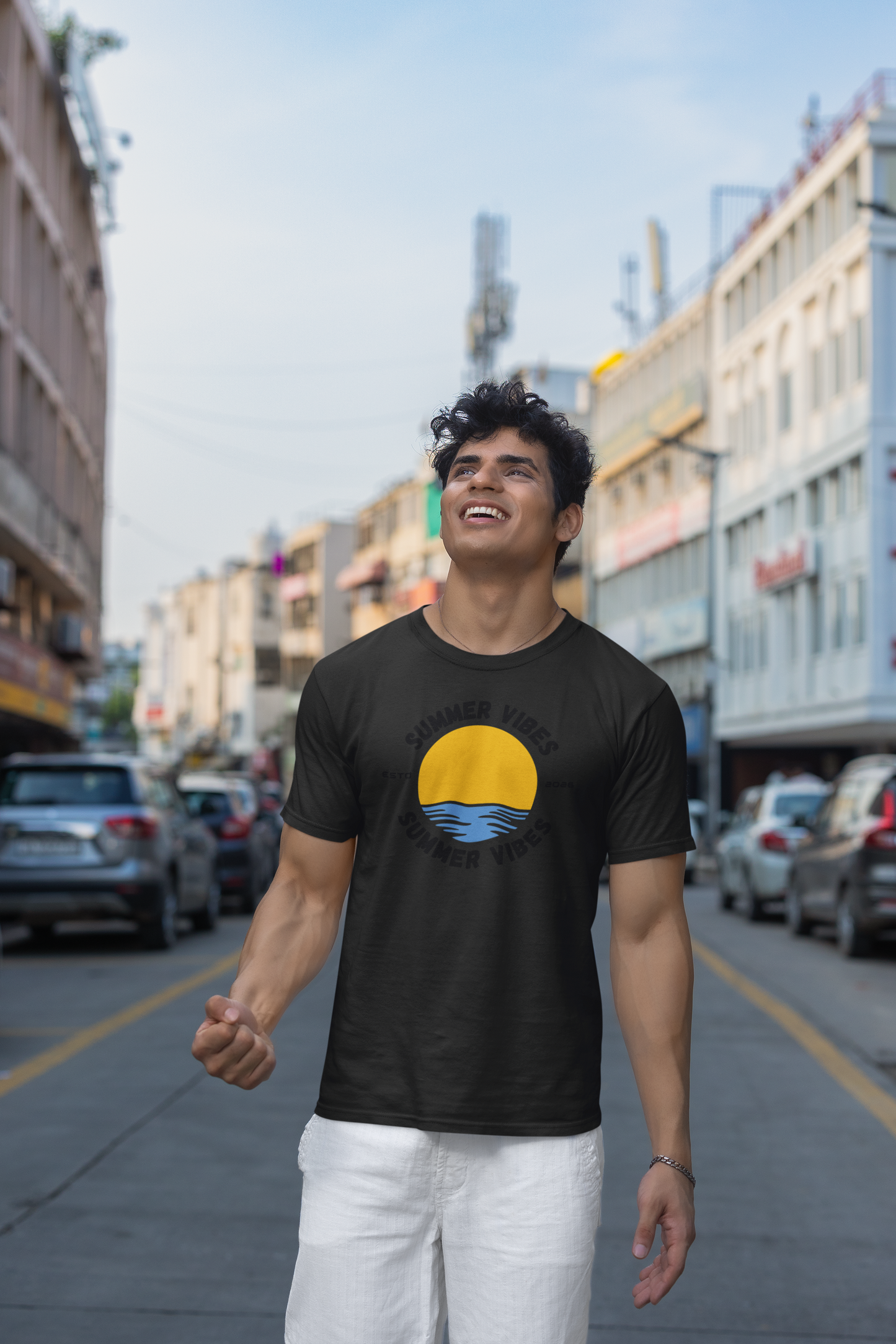 Man wearing a black 'Summer Vibes' t-shirt on a city street