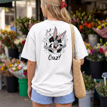 White oversized unisex t-shirt with a Stay Crazy Bugs Bunny graphic breaking through the fabric, back view