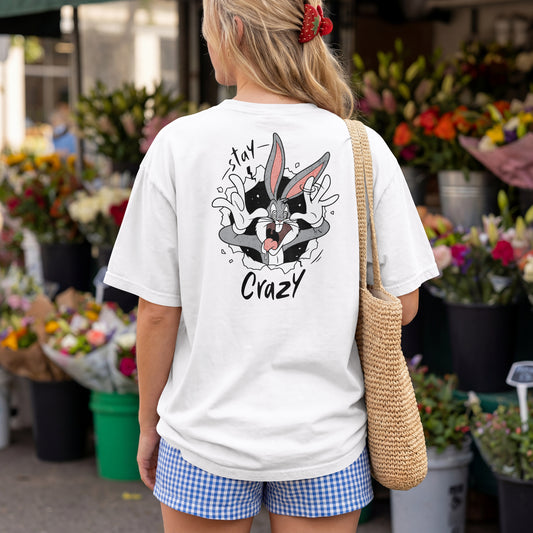 White oversized unisex t-shirt with a Stay Crazy Bugs Bunny graphic breaking through the fabric, back view