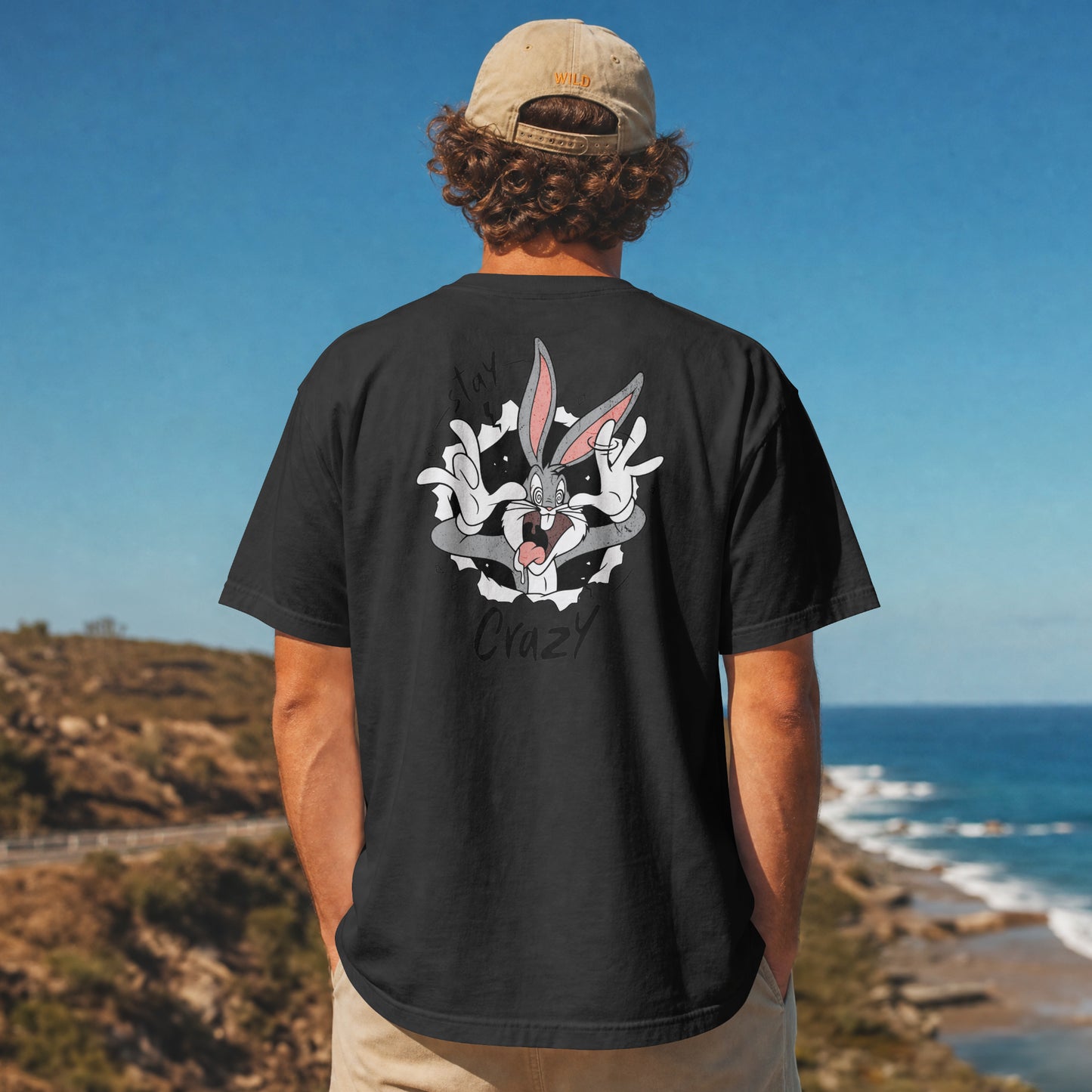 Black oversized unisex t-shirt with a Stay Crazy Bugs Bunny graphic breaking through the fabric, back view