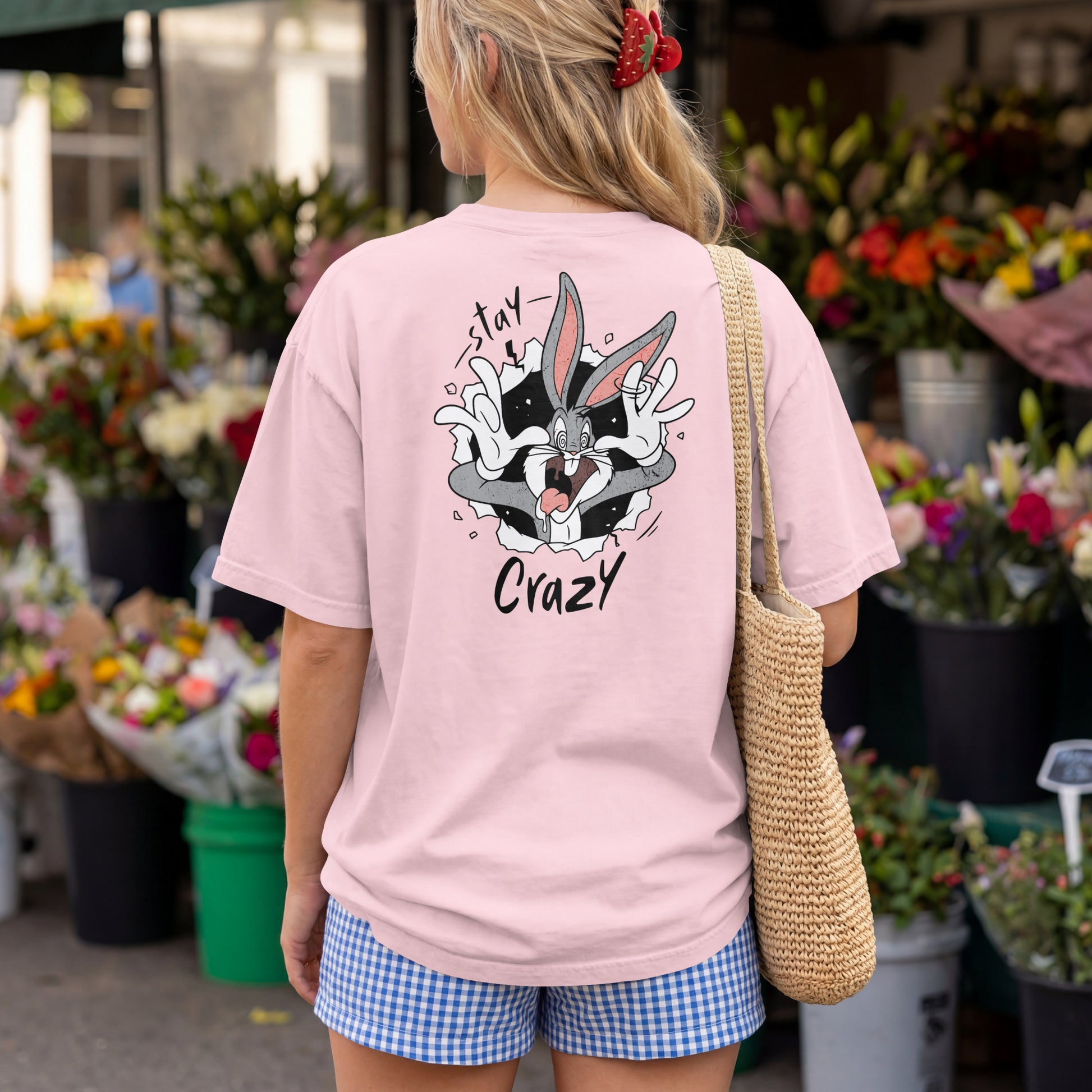 Light Baby Pink oversized unisex t-shirt with a Stay Crazy Bugs Bunny graphic breaking through the fabric, back view