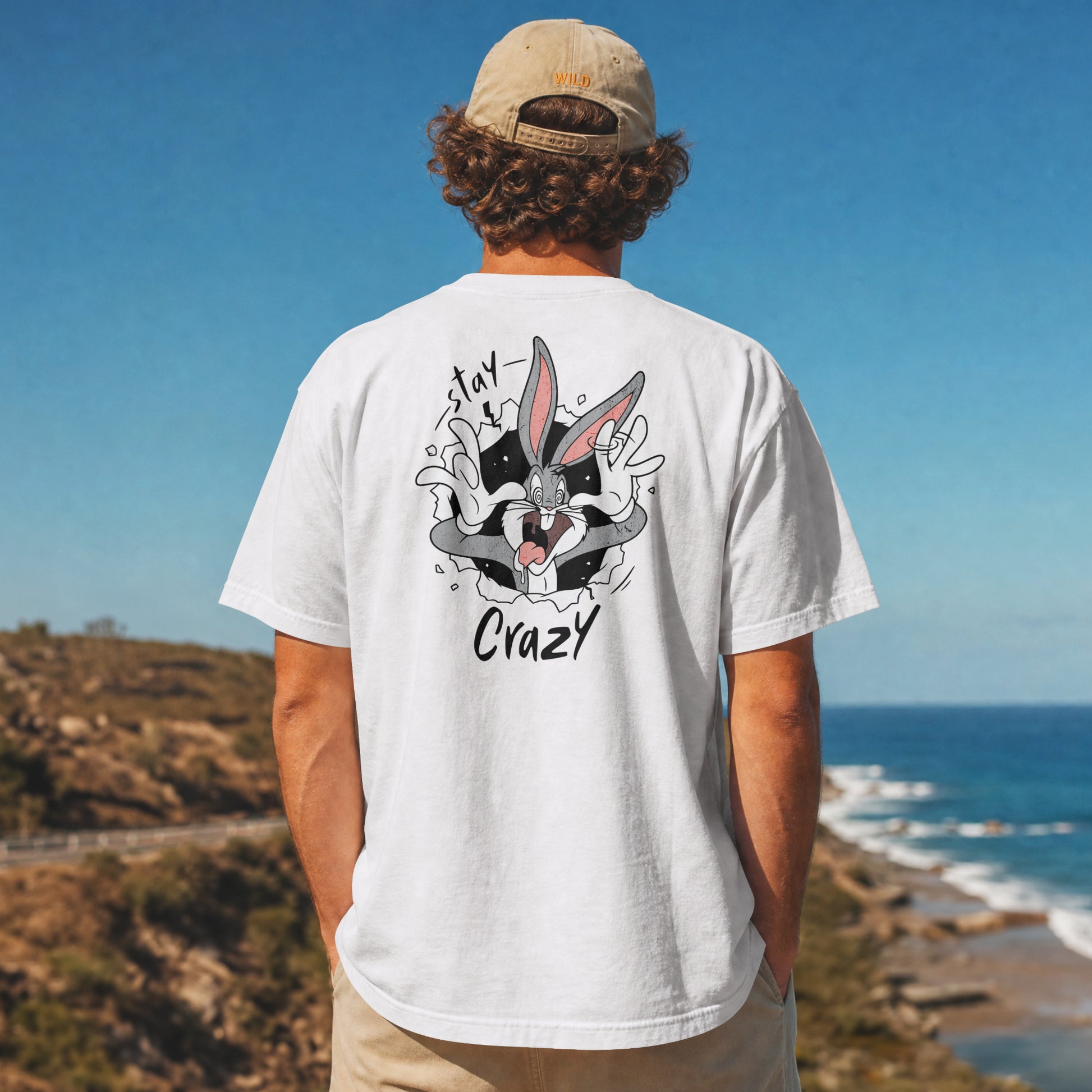 White oversized unisex t-shirt with a Stay Crazy Bugs Bunny graphic breaking through the fabric, back view