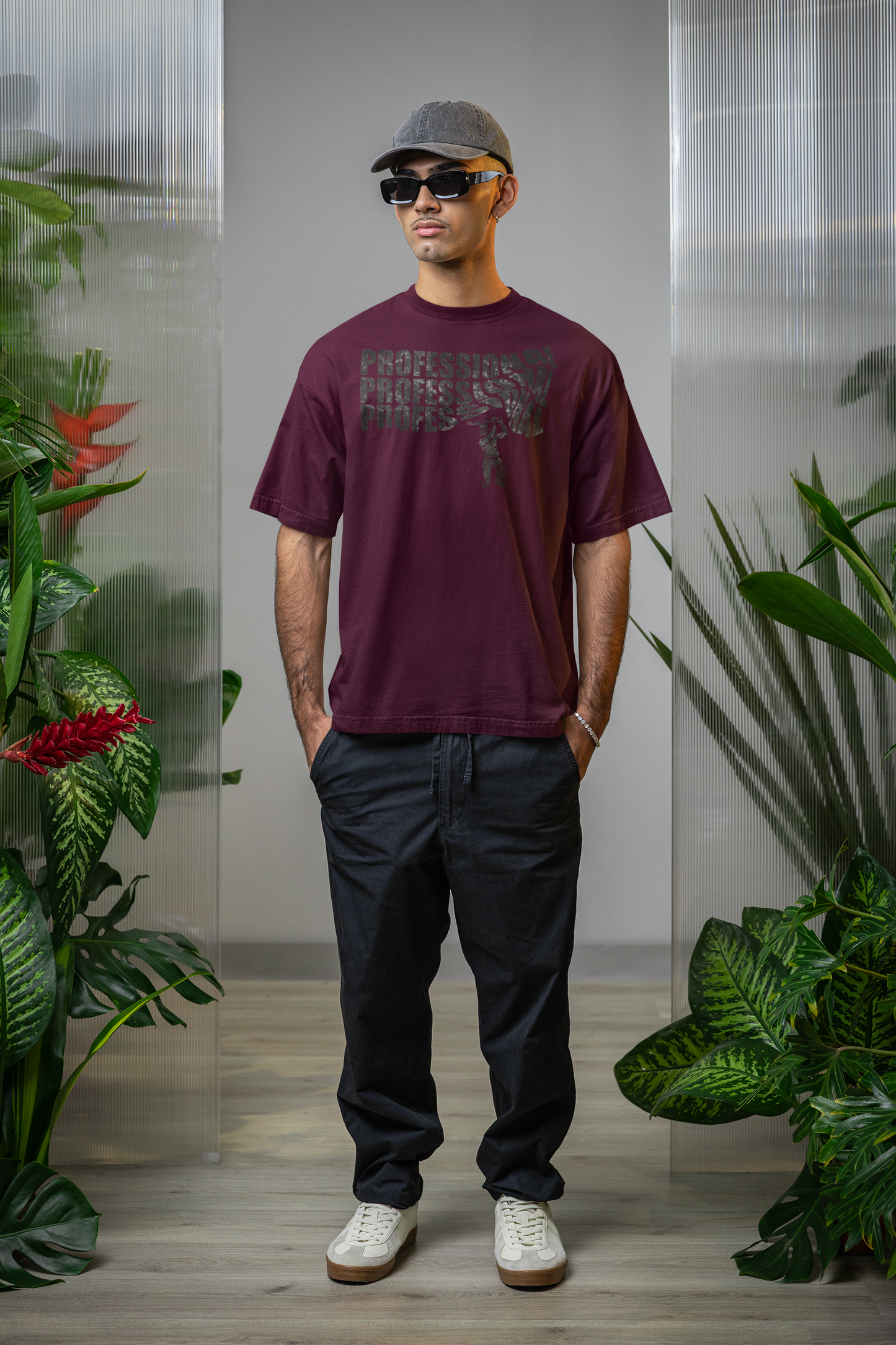 Man wearing a burgundy t-shirt with text professional cricket