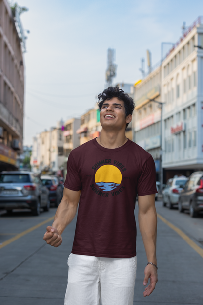 Man wearing a burgundy 'Summer Vibes' t-shirt on a city street