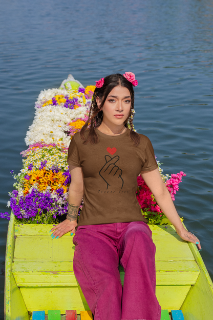 Woman wearing a coffee brown t-shirt with a design on a boat decorated with flowers