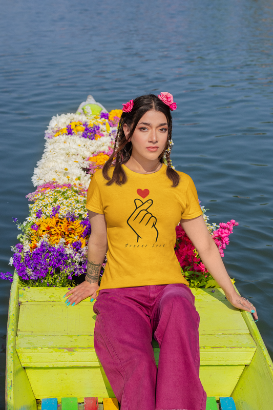 Woman wearing a golden yellow t-shirt with a design on a boat decorated with flowers