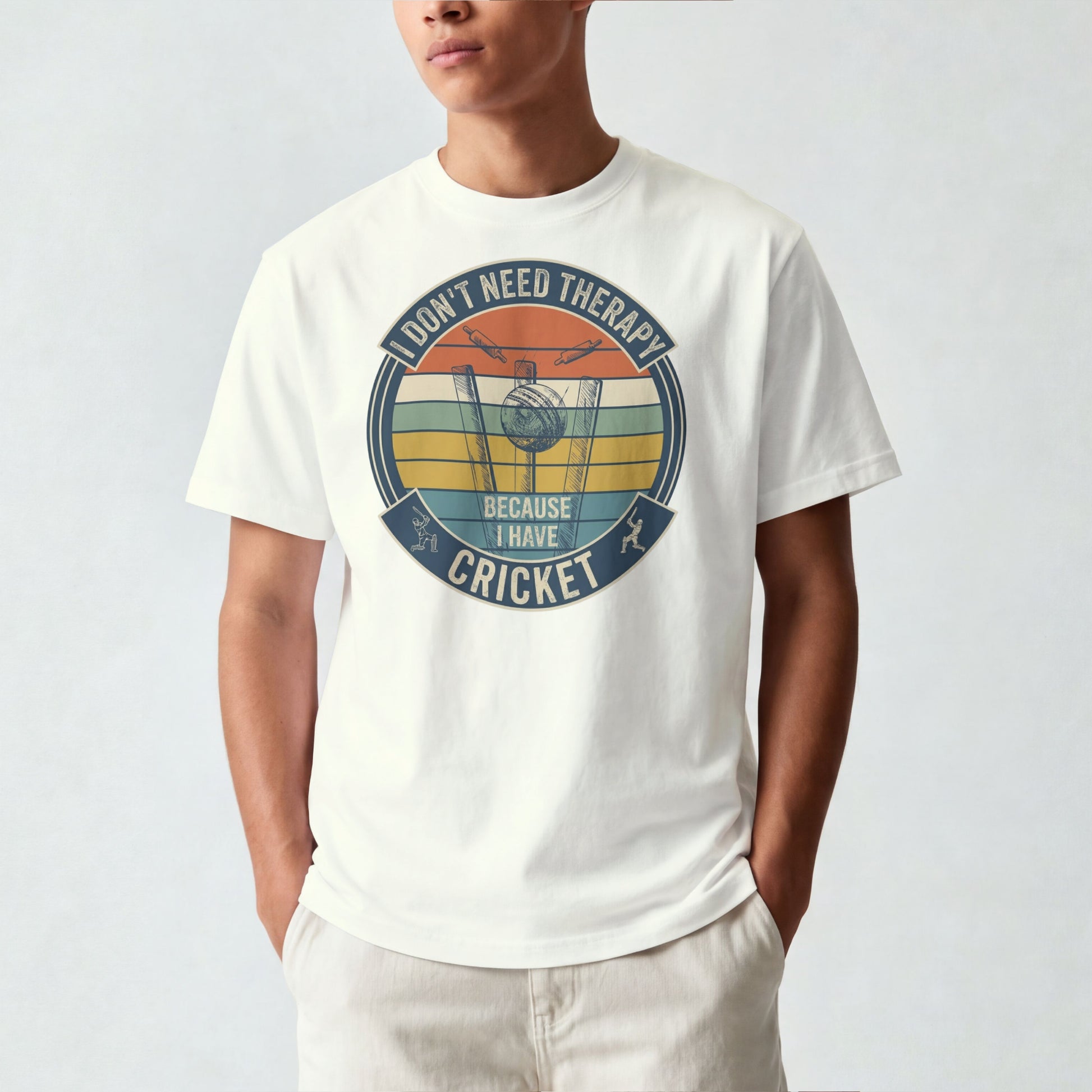 Ivory vintage cricket t-shirt featuring the slogan “I Don’t Need Therapy Because I Have Cricket” with retro sunset stripes, cricket stumps, bat, and ball graphic.