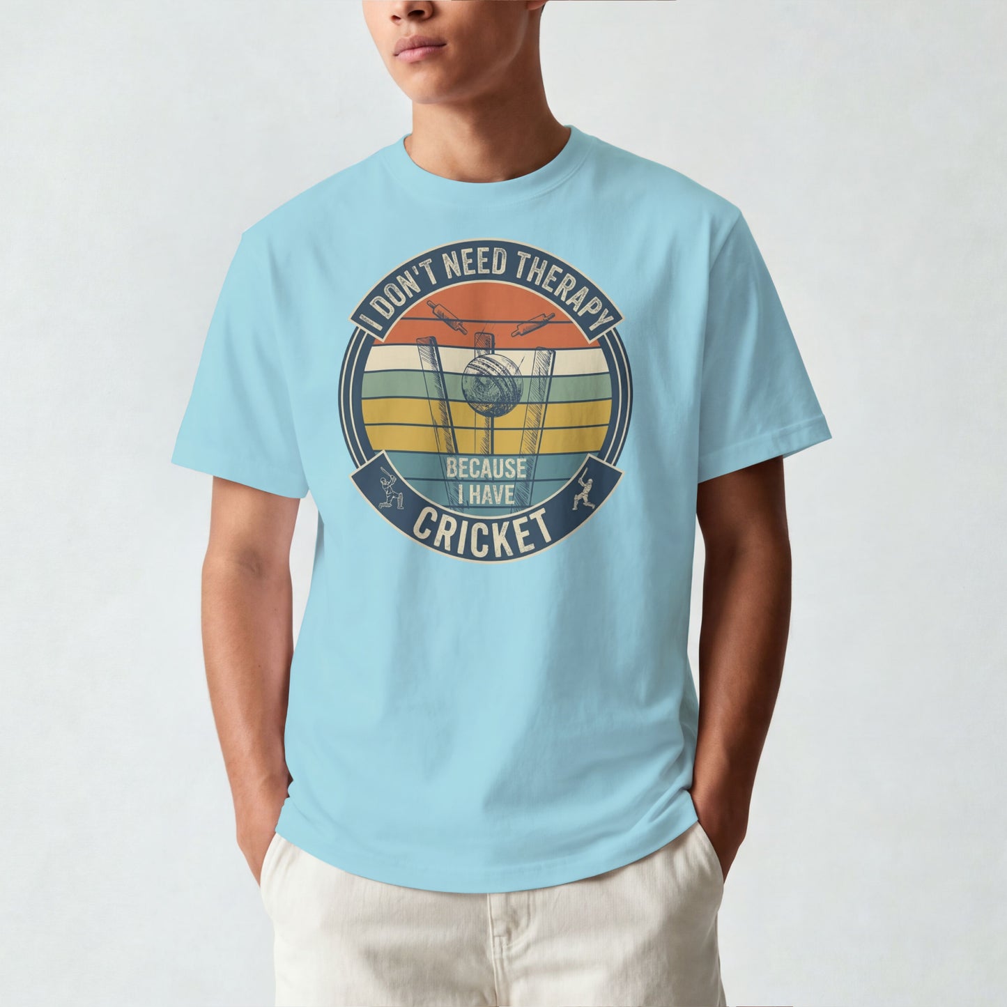 Surf Blue vintage cricket t-shirt featuring the slogan “I Don’t Need Therapy Because I Have Cricket” with retro sunset stripes, cricket stumps, bat, and ball graphic.