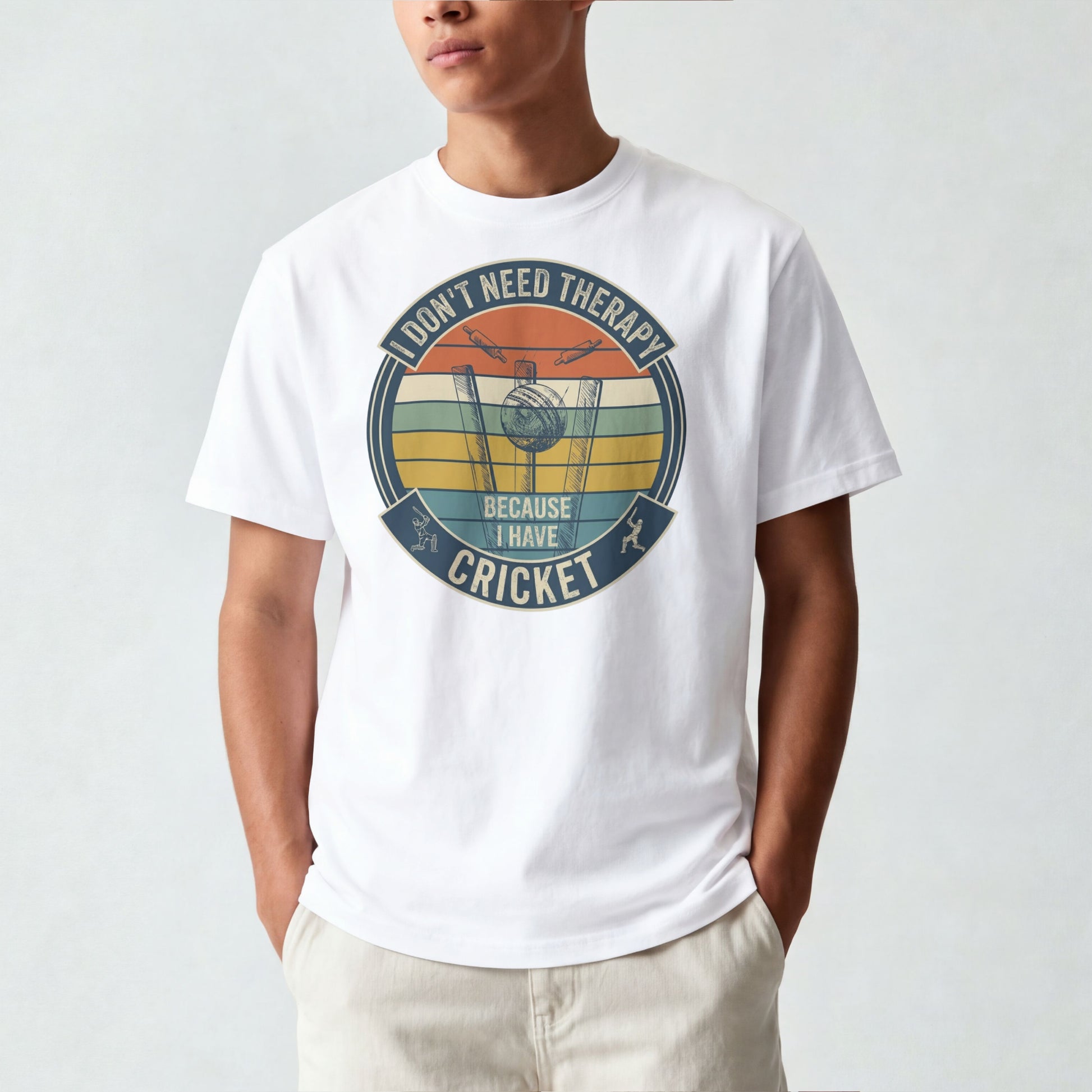 White vintage cricket t-shirt featuring the slogan “I Don’t Need Therapy Because I Have Cricket” with retro sunset stripes, cricket stumps, bat, and ball graphic.