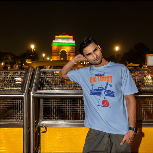 Baby Blue In Cricket We Trust oversized t-shirt design with cricket bat, ball and stadium graphic