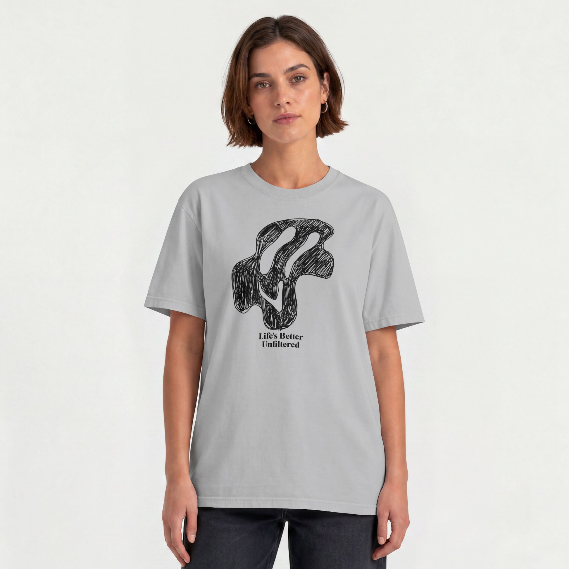 Melange Grey Young woman wearing a relaxed fit cotton tee featuring a melting doodle design and "Life's Better Unfiltered"