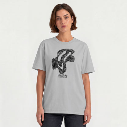 Melange Grey Young woman wearing a relaxed fit cotton tee featuring a melting doodle design and "Life's Better Unfiltered"