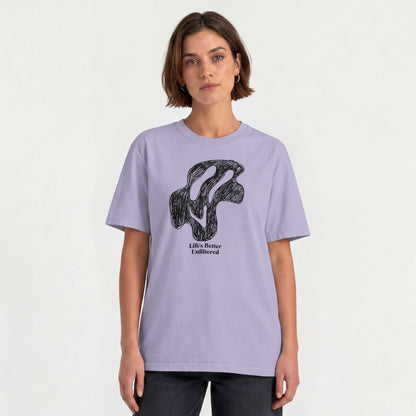 Lavender Young woman wearing a relaxed fit cotton tee featuring a melting doodle design and "Life's Better Unfiltered"