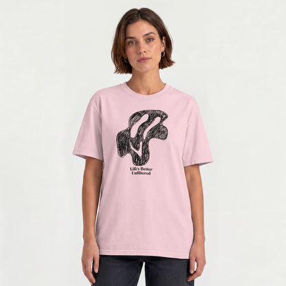 Light Baby Pink Young woman wearing a relaxed fit cotton tee featuring a melting doodle design and "Life's Better Unfiltered"