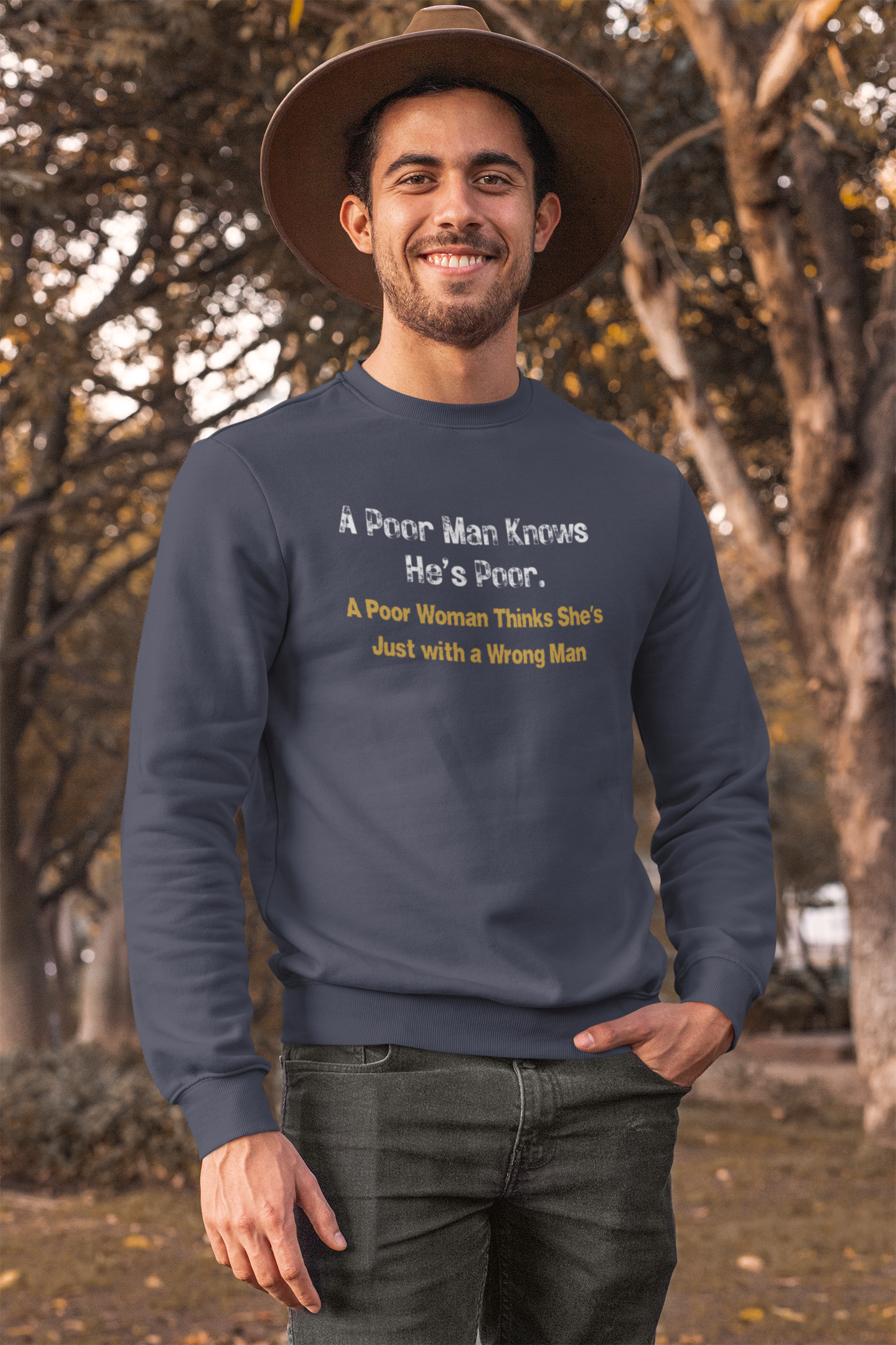 Man wearing a navy blue sweatshirt with humorous text in an outdoor setting