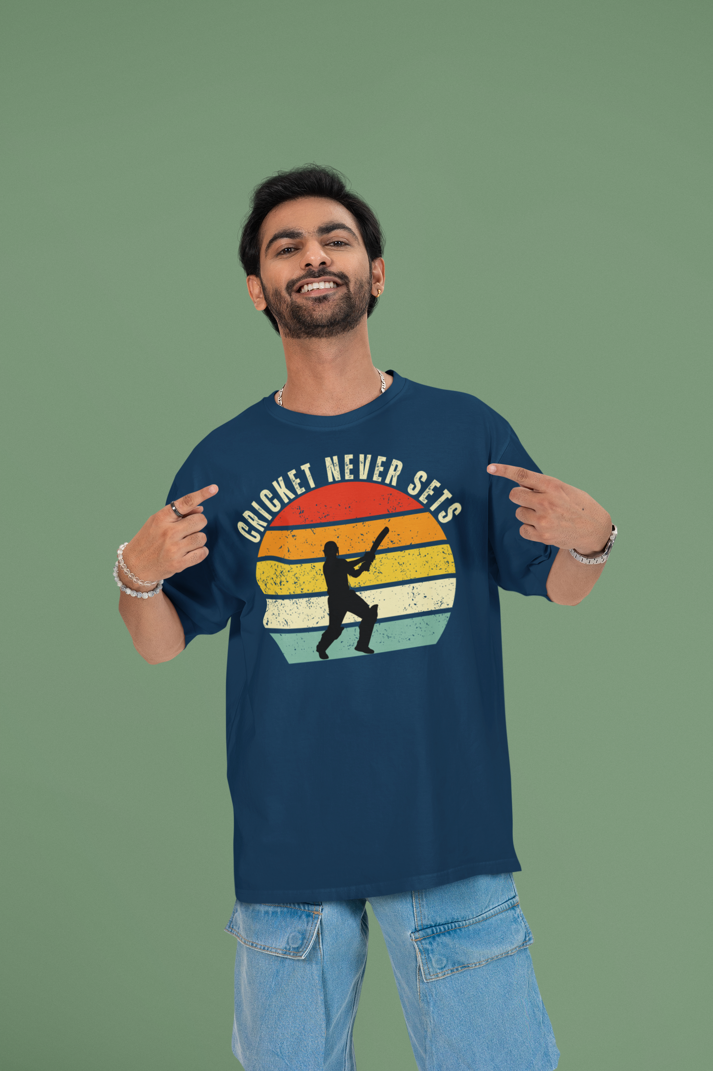 Man wearing a cricket never sets navy blue t-shirt with a colorful graphic and text