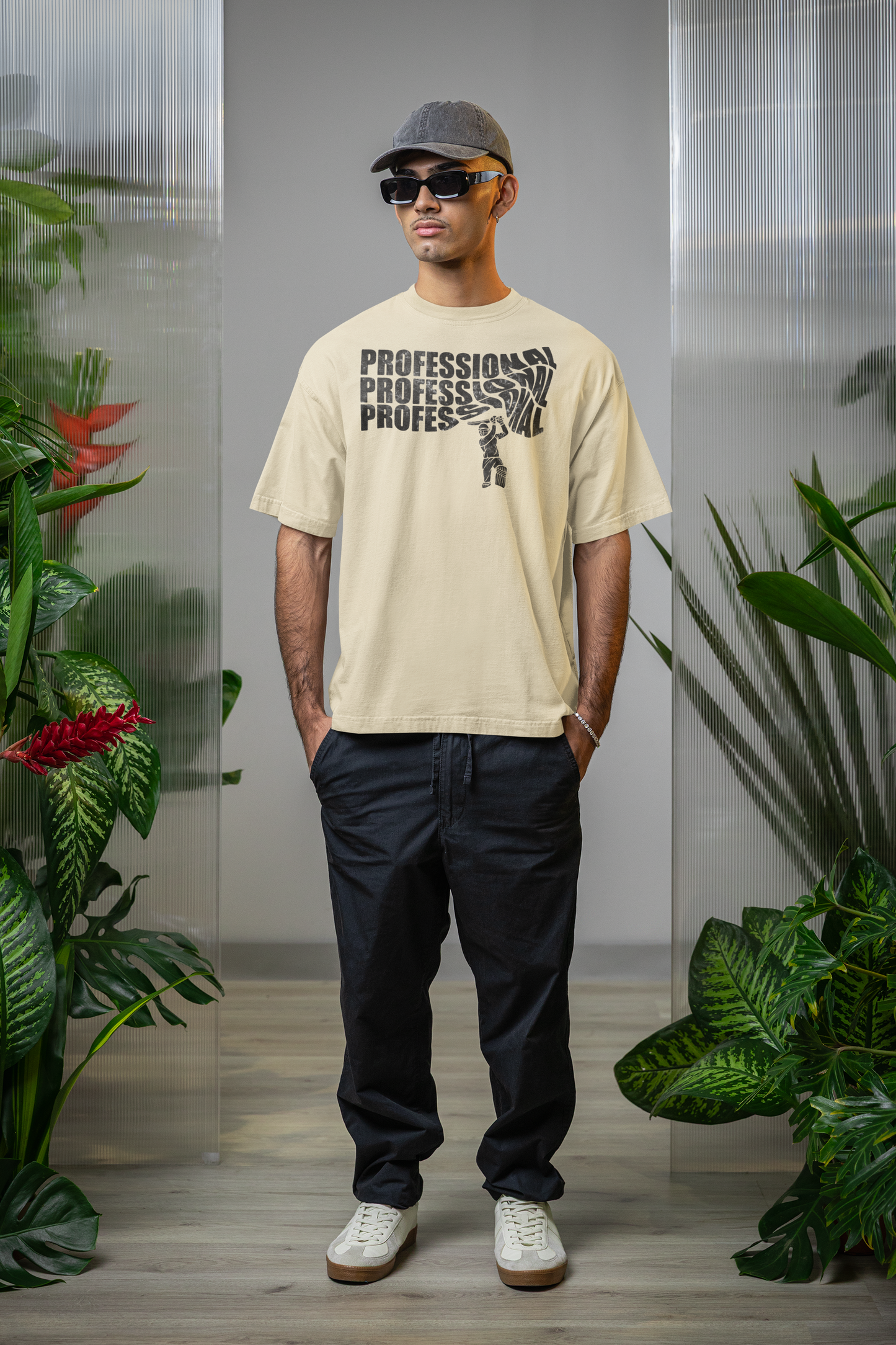 Man wearing a off white t-shirt with text professional cricket