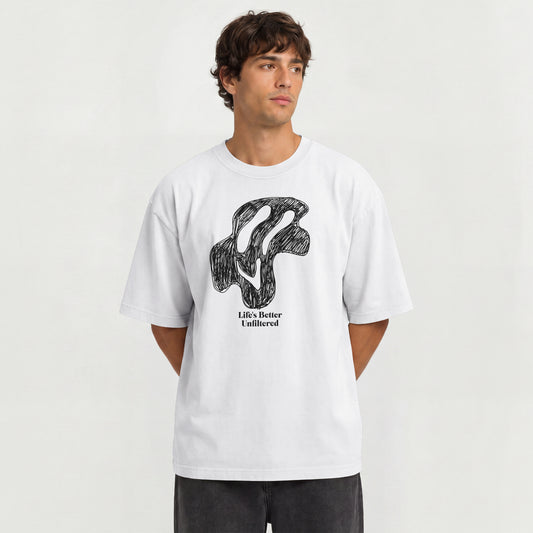 White Young man in oversized streetwear T-shirt with "Life's Better Unfiltered" trippy graphic print.