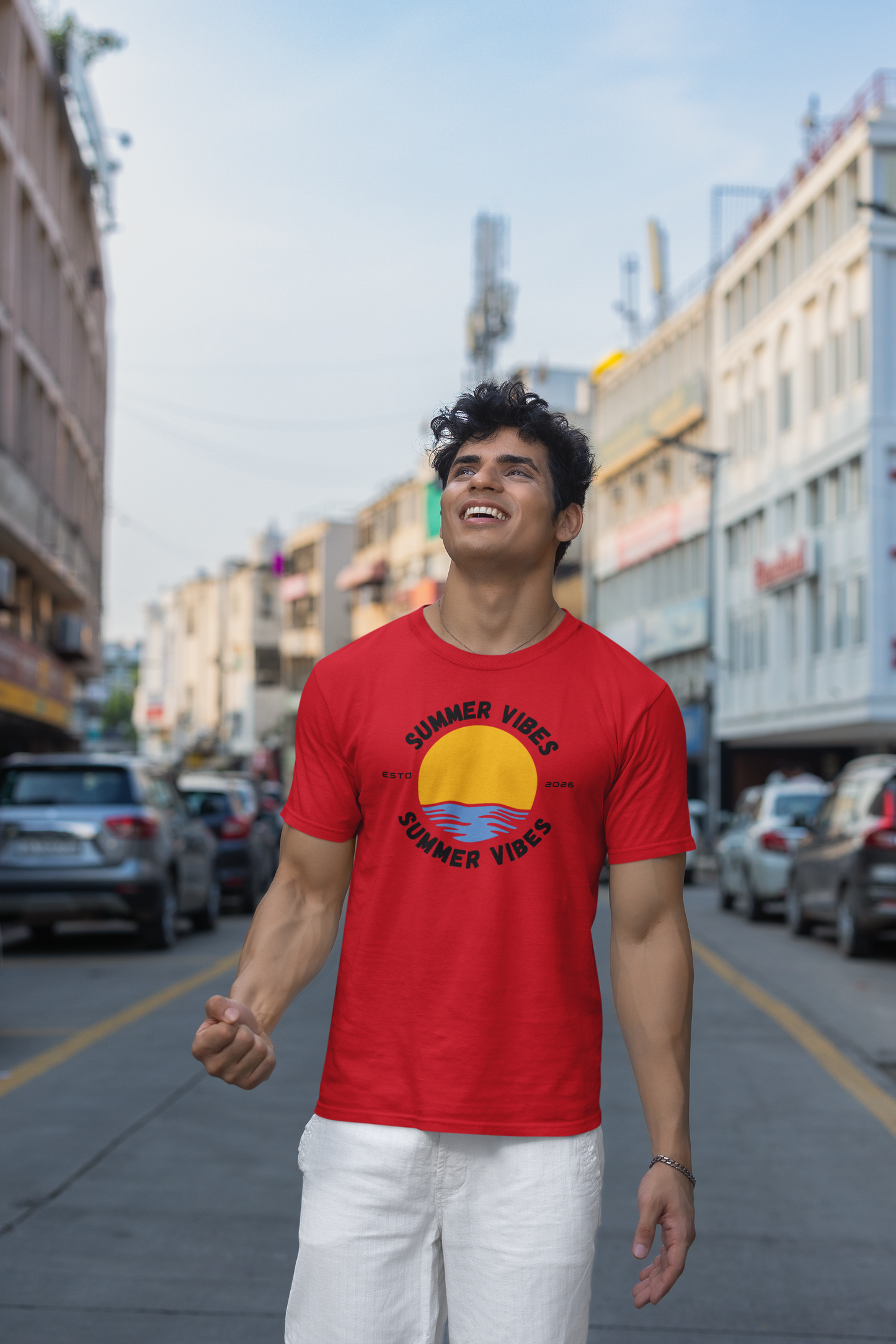 Man wearing a red 'Summer Vibes' t-shirt on a city street