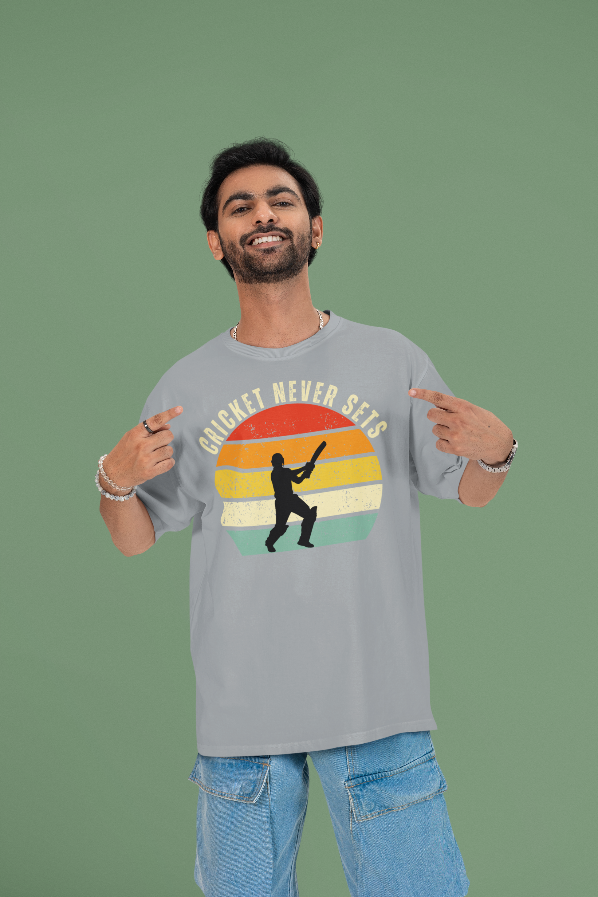 Man wearing a cricket never sets silver frost t-shirt with a colorful graphic and text